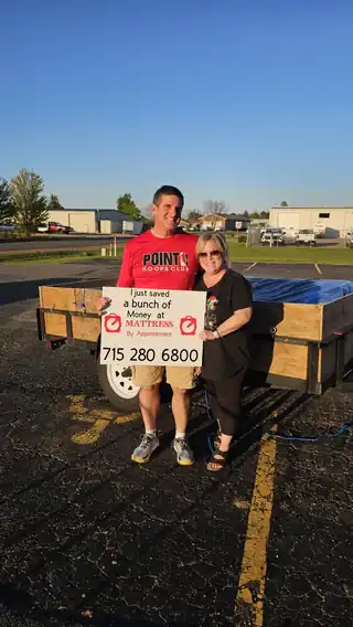 Happy couple with their new mattress